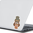 Load image into Gallery viewer, Mr. Owl is a distinguished looking steampunk owl with top hat and a pocket watch medallion. This image shows the Mr. Owl sticker on the back of an open laptop.