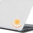 Load image into Gallery viewer, Let the Sun Shine! This bright and fun individual die-cut sticker features a yellow and orange sun with the words "Let the Sun Shine!" below. This image shows the Let the Sun Shine! sticker on the back of an open laptop.