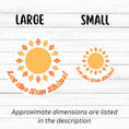 Load image into Gallery viewer, Let the Sun Shine! This bright and fun individual die-cut sticker features a yellow and orange sun with the words "Let the Sun Shine!" below. This image shows large and small Let the Sun Shine! stickers next to each other.