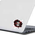 Load image into Gallery viewer, Trash Polka uses red, black, and white with a combination of abstract, surrealistic, and realistic images, and this individual die-cut sticker features a sugar skull woman with roses in her hair on a black background with a red grid. This image shows the trash polka sugar skull sticker on the back of an open laptop.
