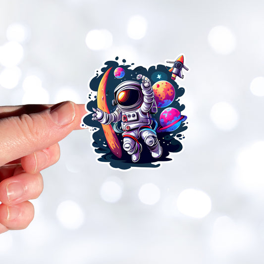 This image shows a hand holding the astronaut spacewalk sticker.