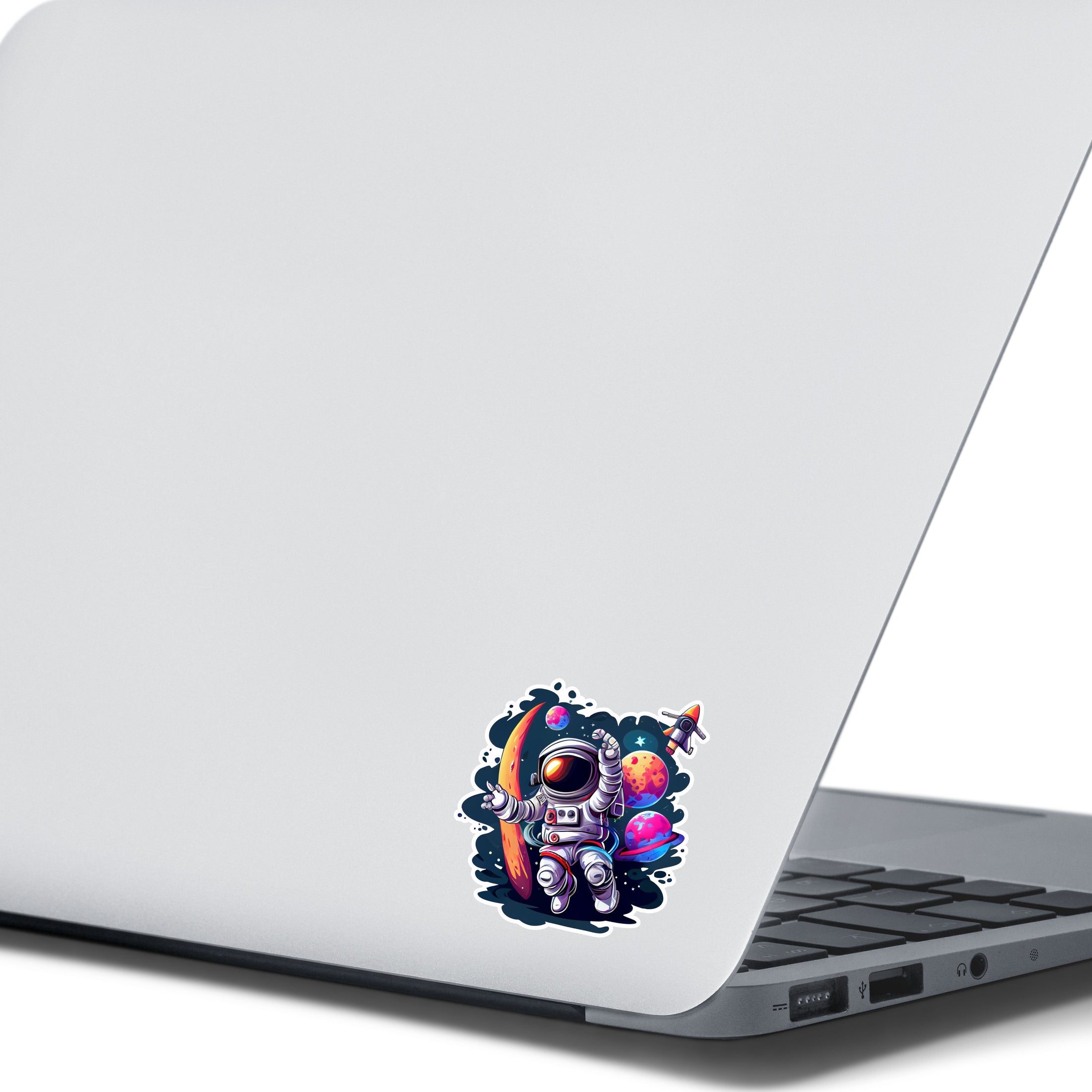 This image shows the astronaut spacewalk sticker on the back of an open laptop.