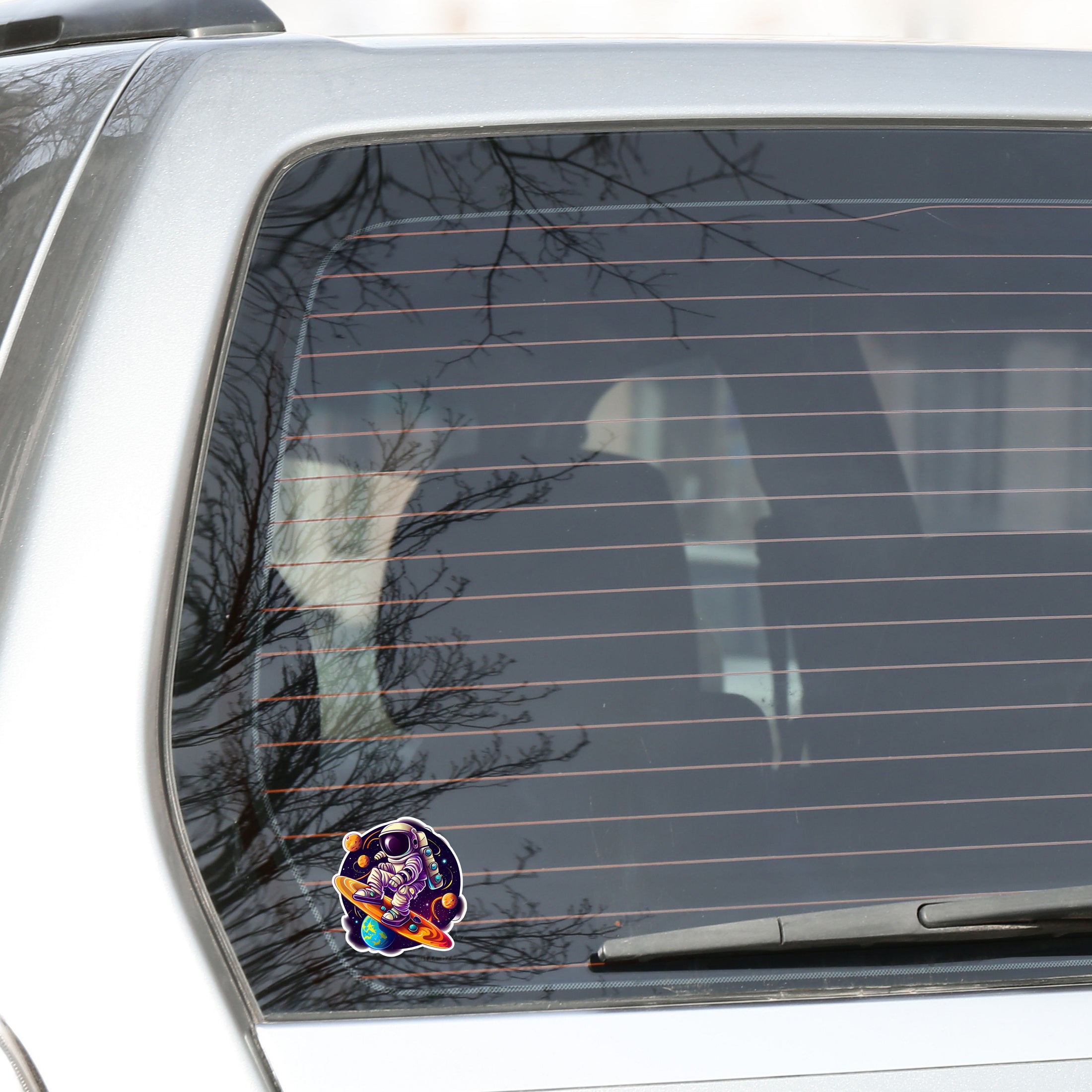 This image show the astronaut surfing sticker on the back window of a car.r