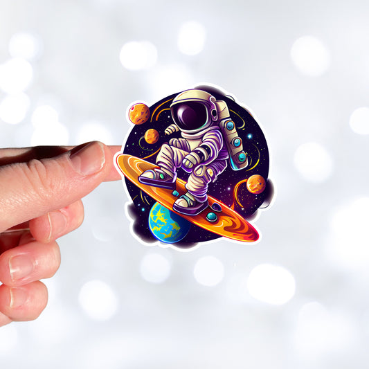 This image show a hand holding the astronaut surfing sticker