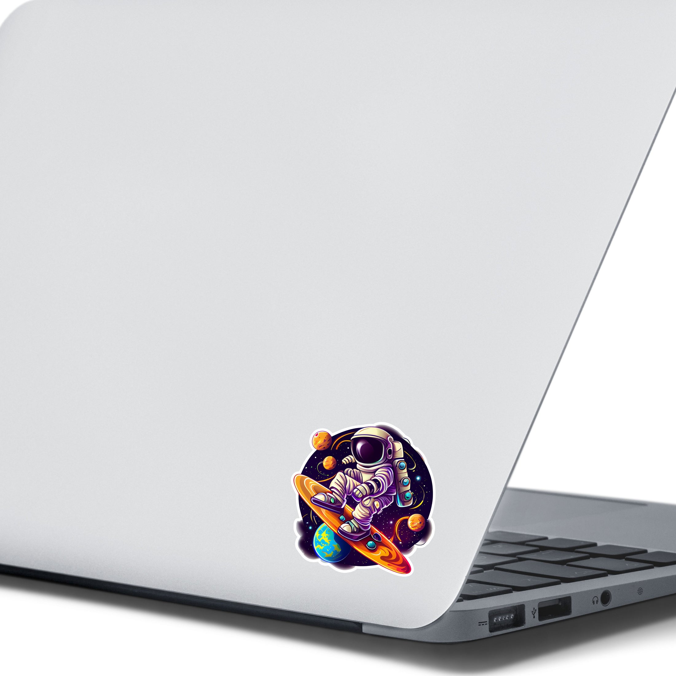 This image shows the astronaut surfing sticker on the back of an open laptop.