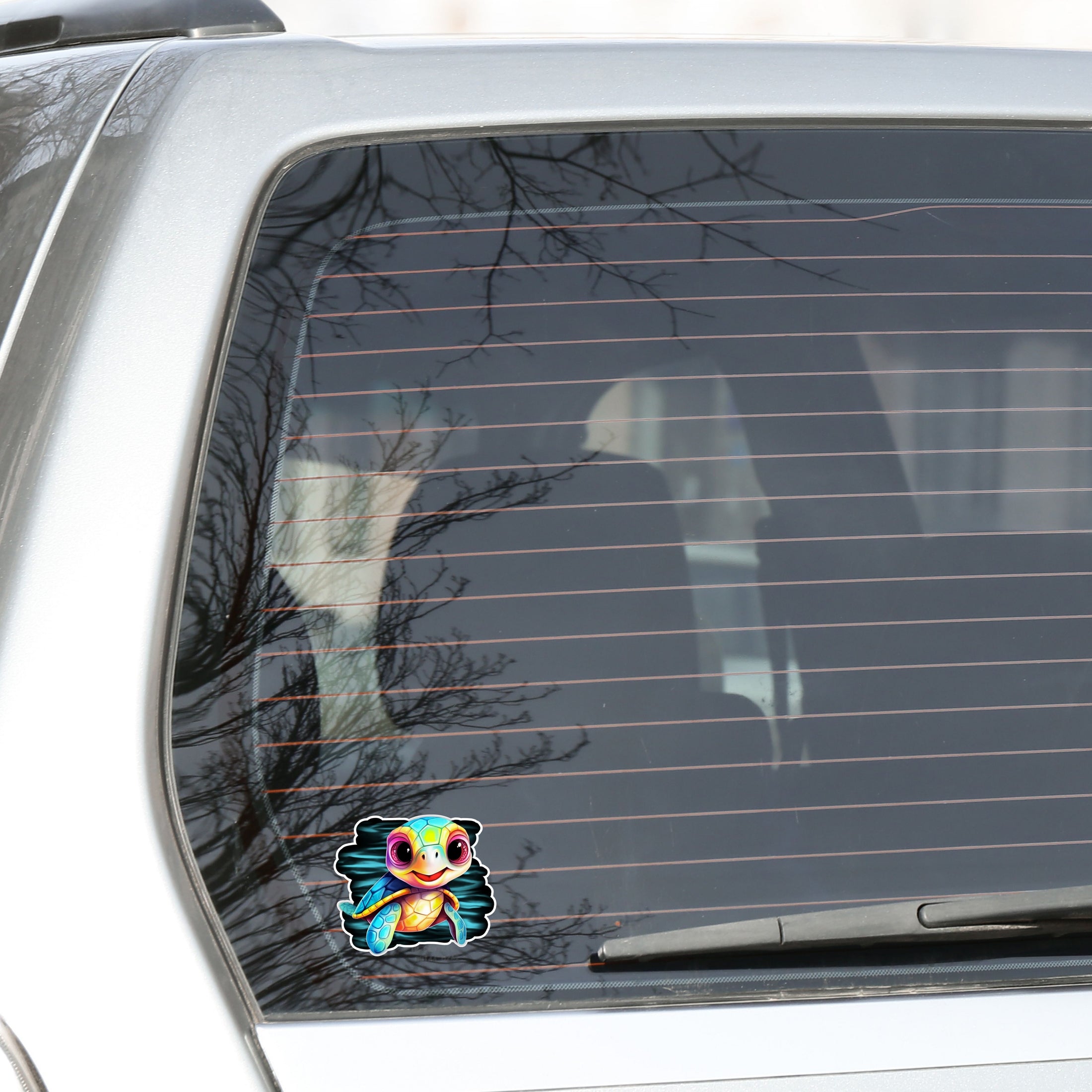 This image shows the baby sea turtle sticker on the back window of a car.