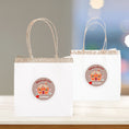 Load image into Gallery viewer, This image shows the personalized holiday stickers on two bags.
