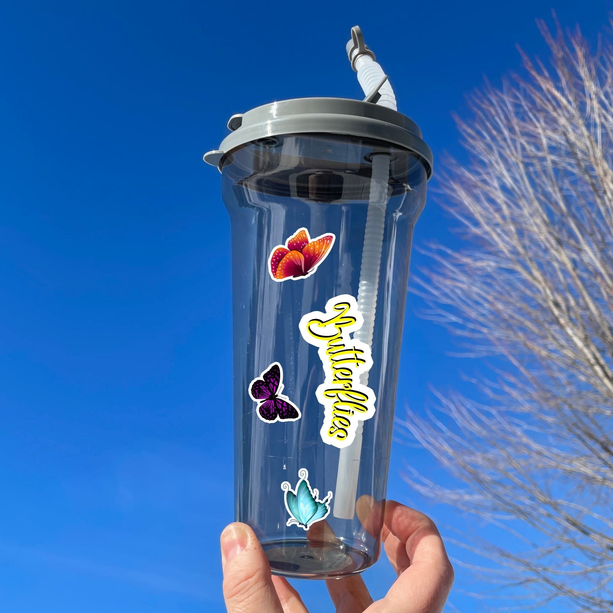 This image shows a water bottle with some of the Butterfly stickers applied.