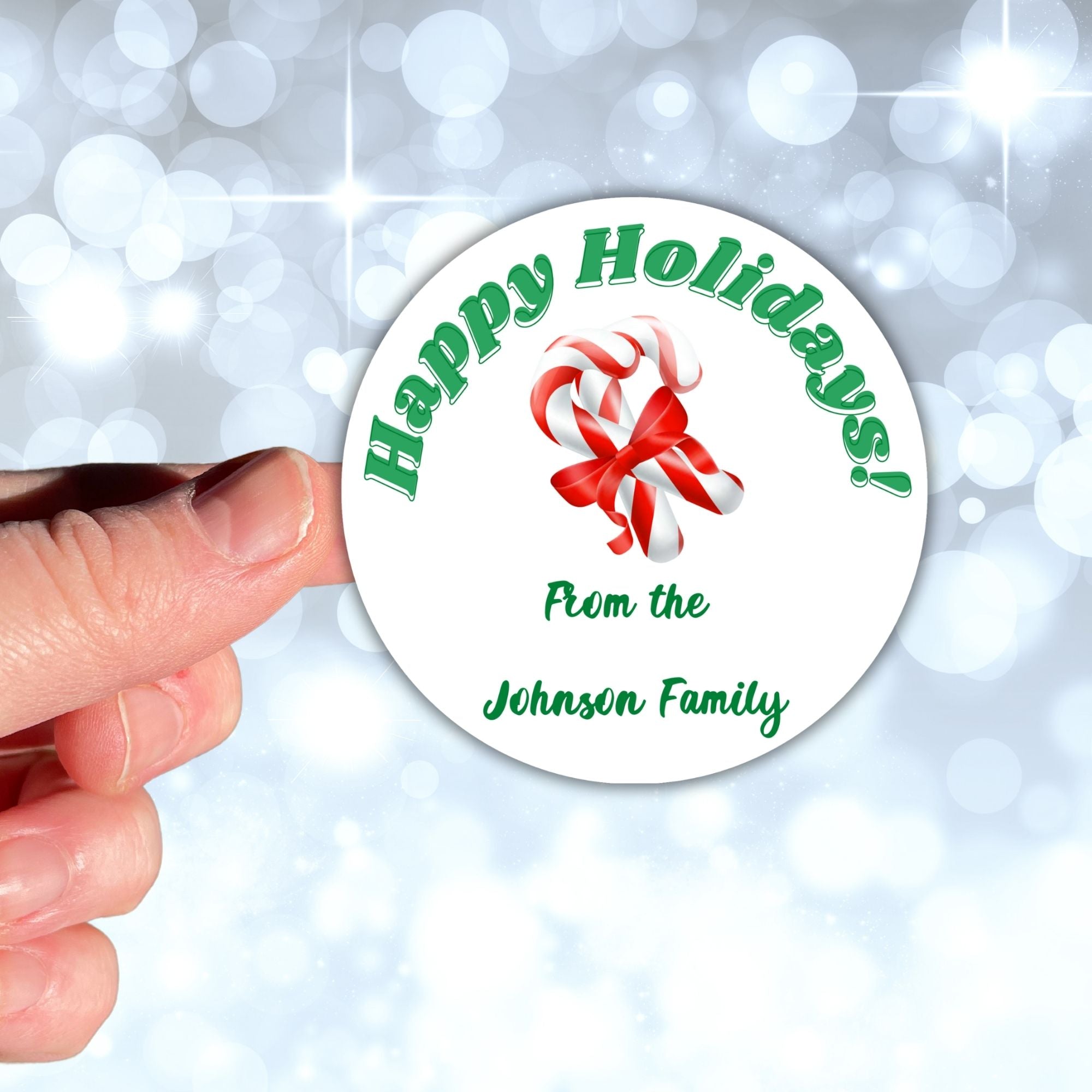 This image shows a hand holding the Personalized Holiday Stickers - Candy Cane Holidays.