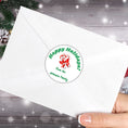 Load image into Gallery viewer, This image shows the Personalized Holiday Stickers - Candy Cane Holidays on the back of an envelope.
