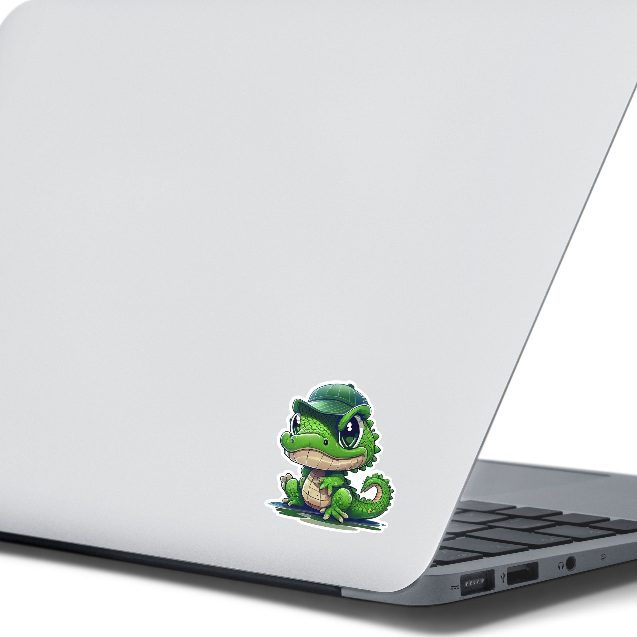 This image shows the crocodile wearing hat sticker on the back of an open laptop.