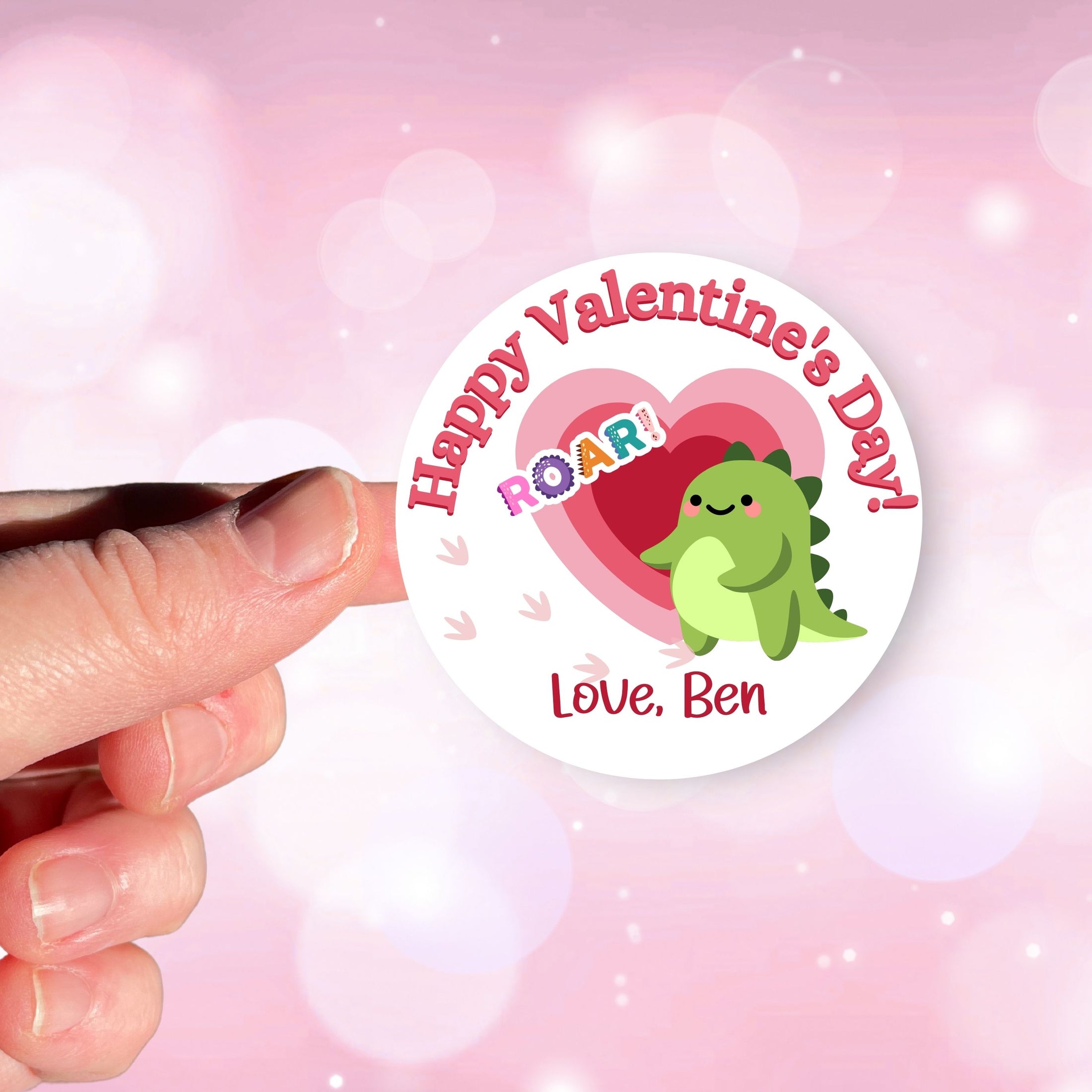 This image shows a hand holding the personalized valentine sticker.