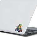 Load image into Gallery viewer, This image shows the dino on ATV sticker on the back of an open laptop.

