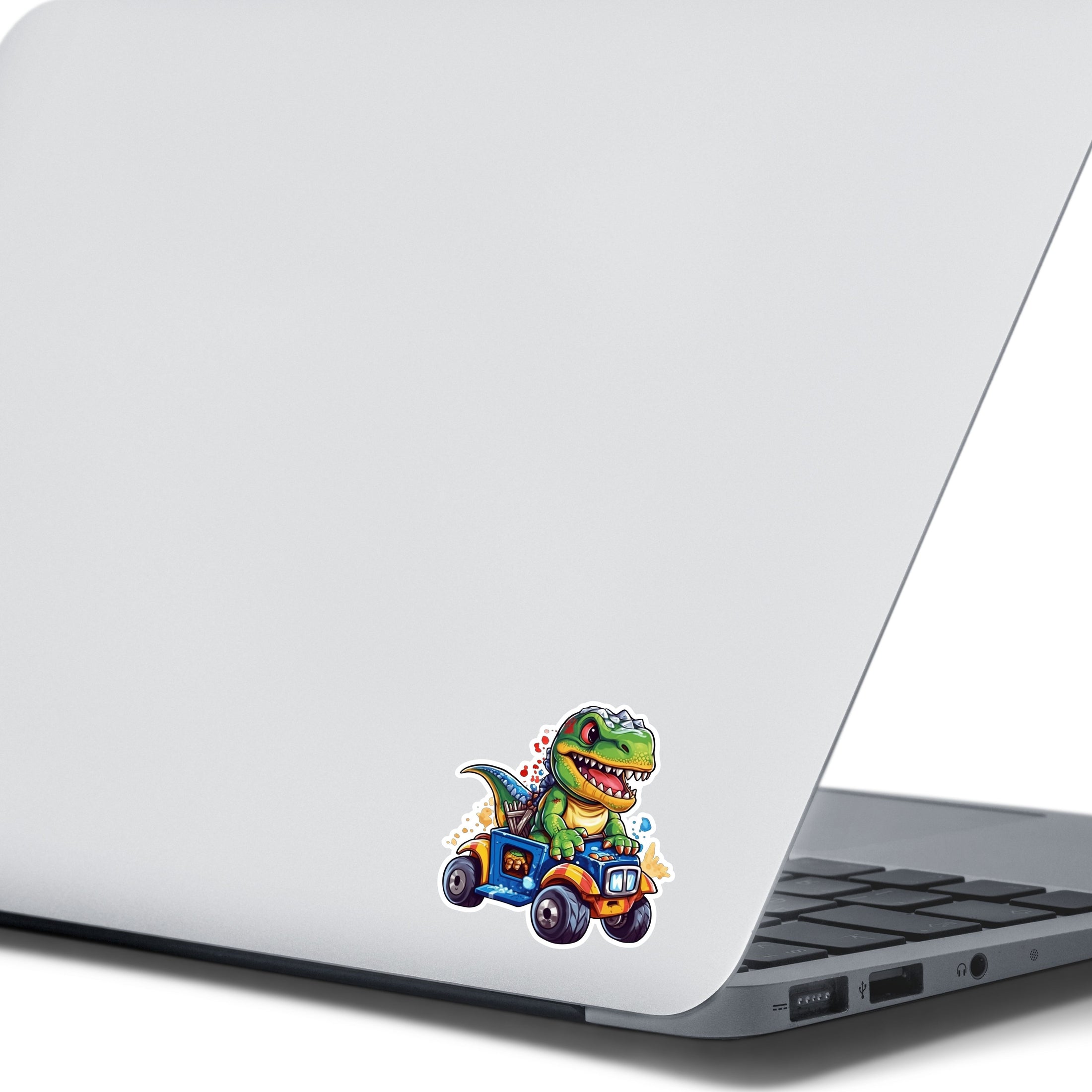 This image shows the dino on ATV sticker on the back of an open laptop.