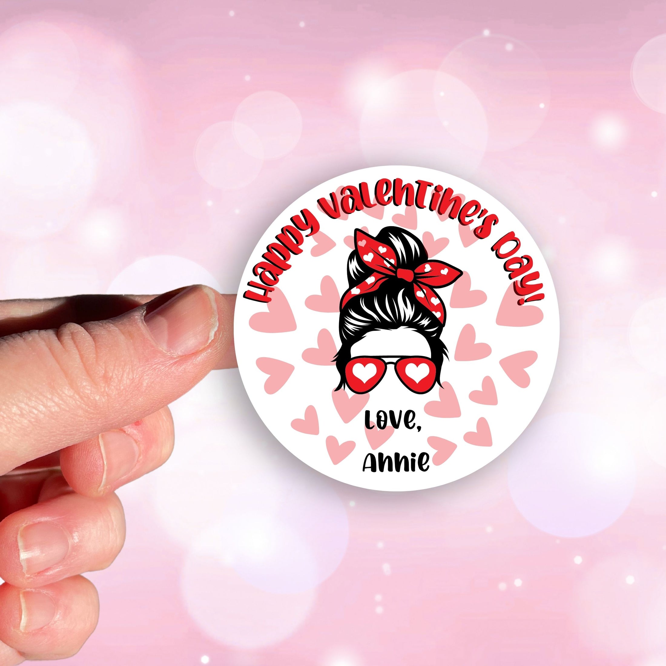 This image shows a hand holding the personalized valentine sticker.