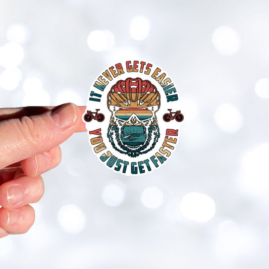 This image shows a hand holding the Keep Biking - Gorilla Die-Cut Sticker.