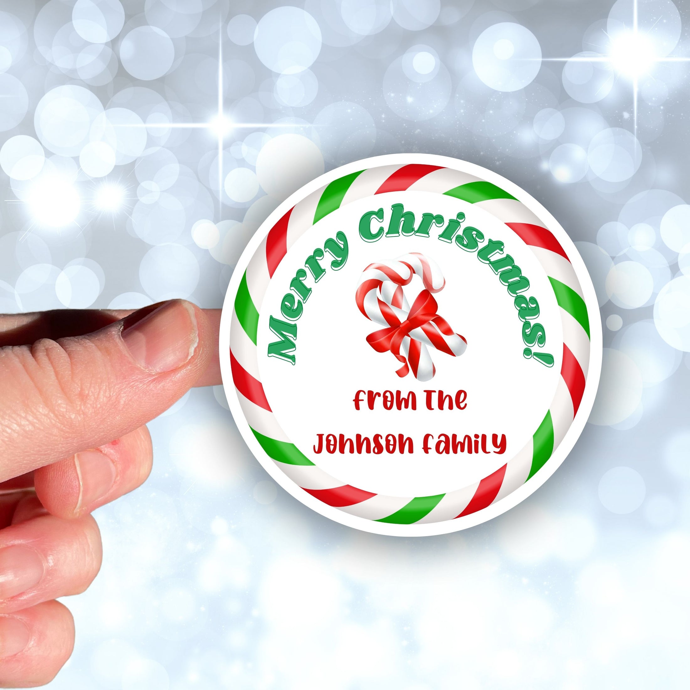 This image shows the personalized holiday sticker being held on one finger over a background of bubbles.