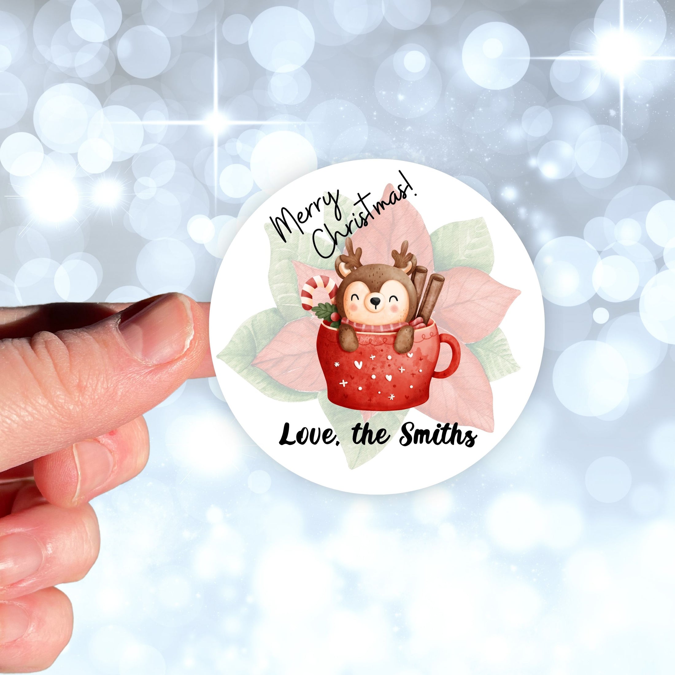 This image shows the personalized holiday sticker being held on one finger over a background of bubbles.