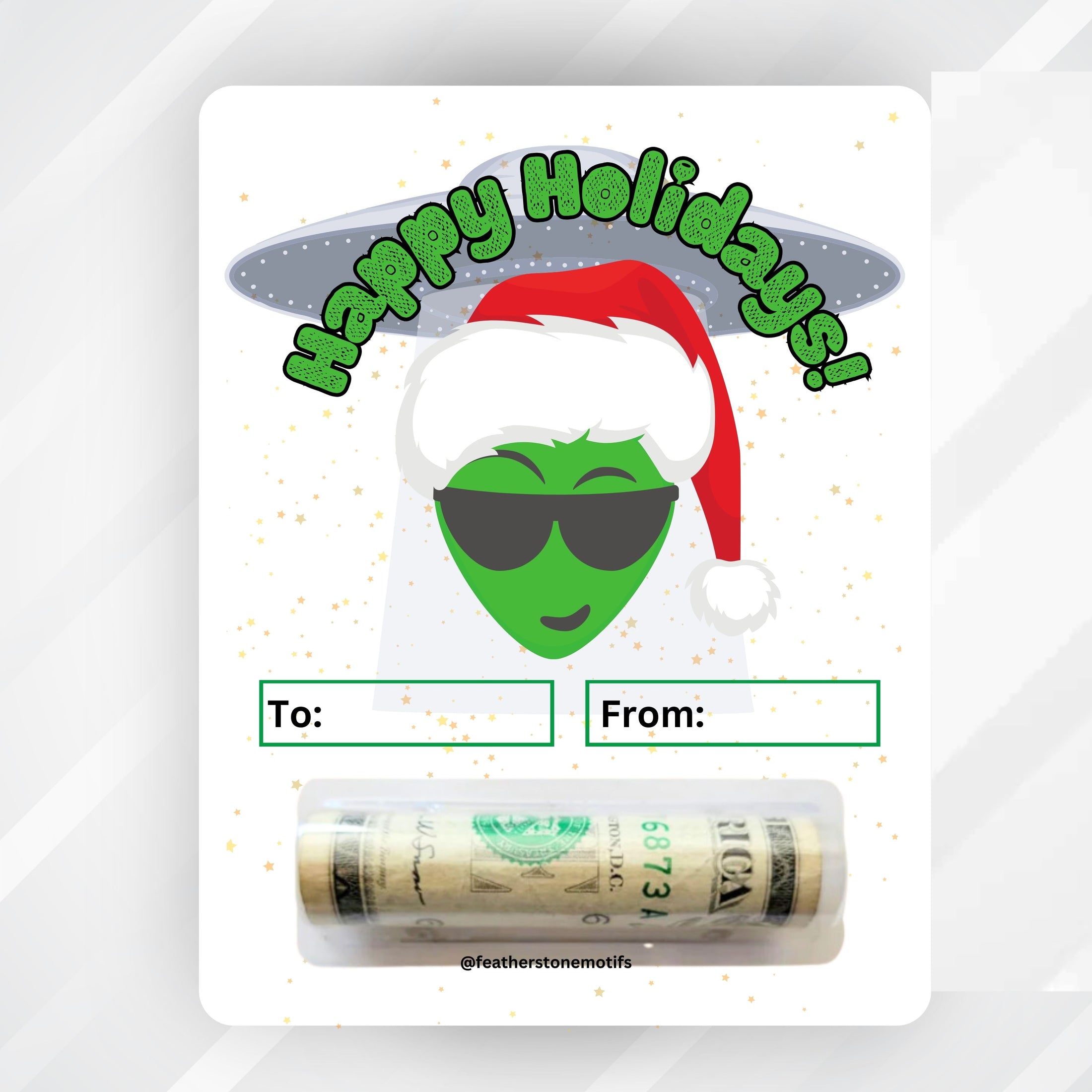 This image shows the Alien Holidays money card with money tube attached