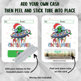 Load image into Gallery viewer, This image shows how to attach the money tube to the Alien Christmas Money Card.
