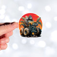 Load image into Gallery viewer, This image shows a hand holding the gorilla monster truck sticker.
