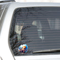 Load image into Gallery viewer, This image shows the Big Eyed Octopus Die-Cut Sticker on the back window of a car.
