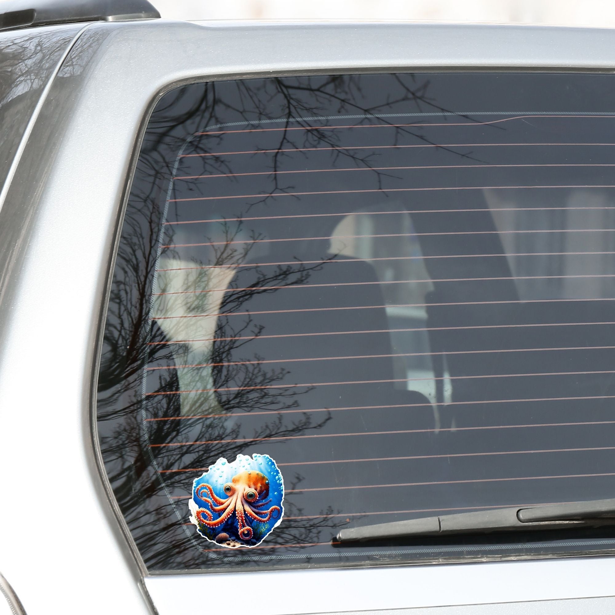 This image shows the Big Eyed Octopus Die-Cut Sticker on the back window of a car.