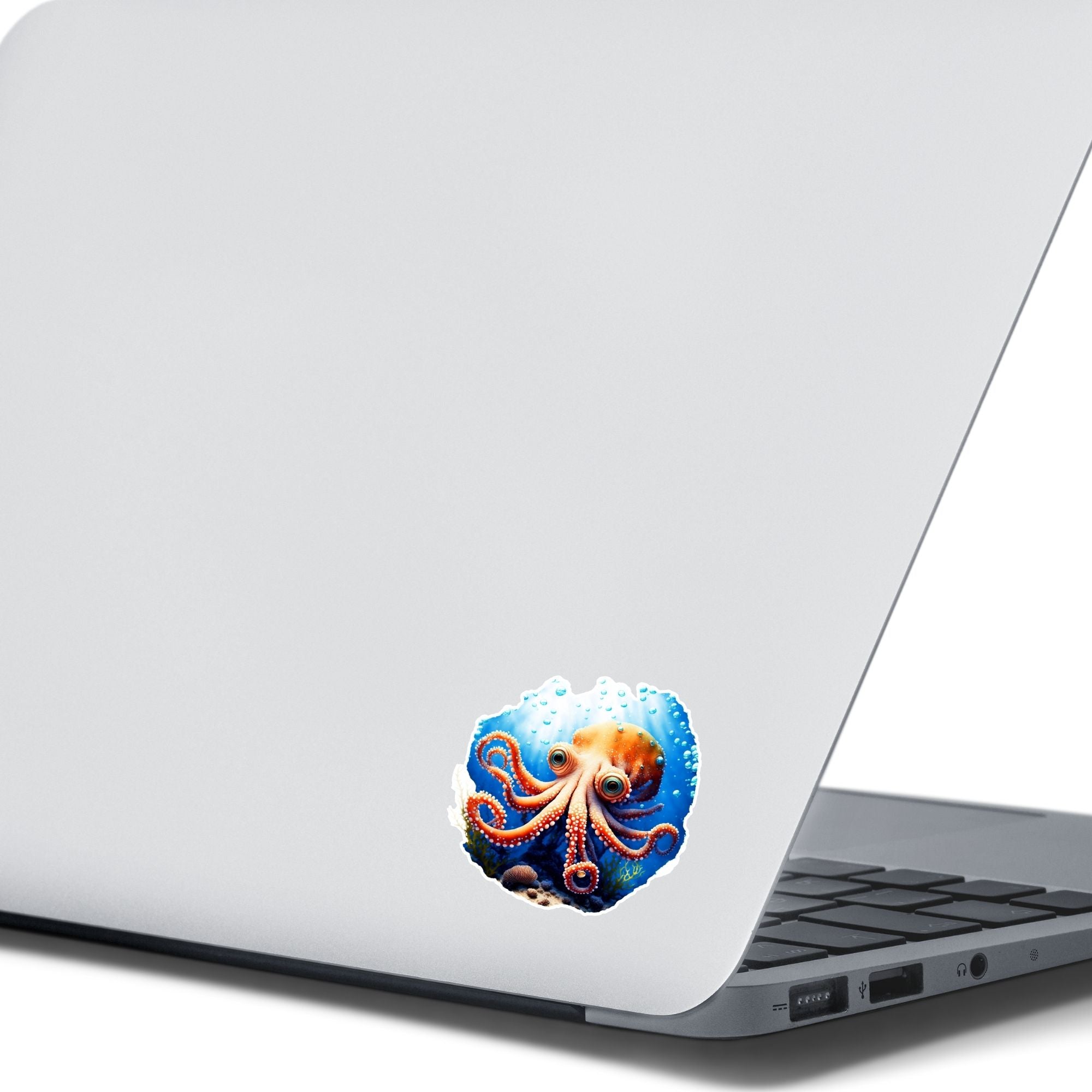 This image shows the Big Eyed Octopus Die-Cut Sticker on the back of an open laptop.