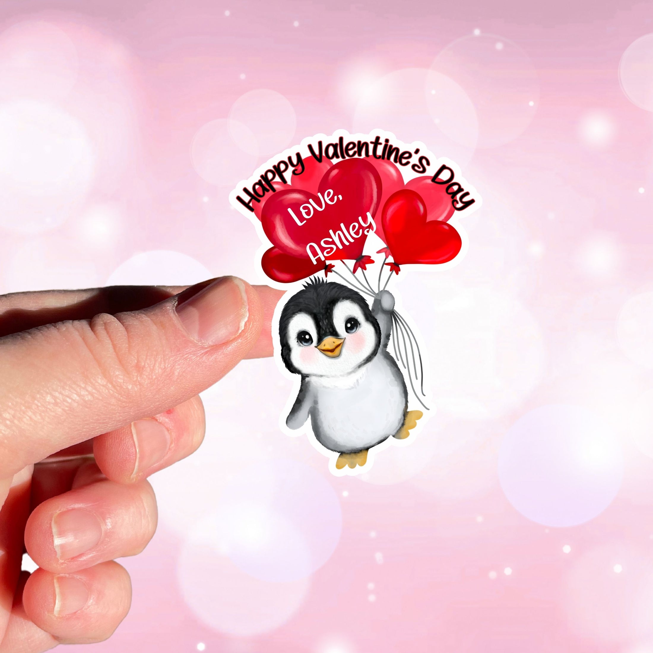 This image shows a hand holding the personalized valentine sticker.