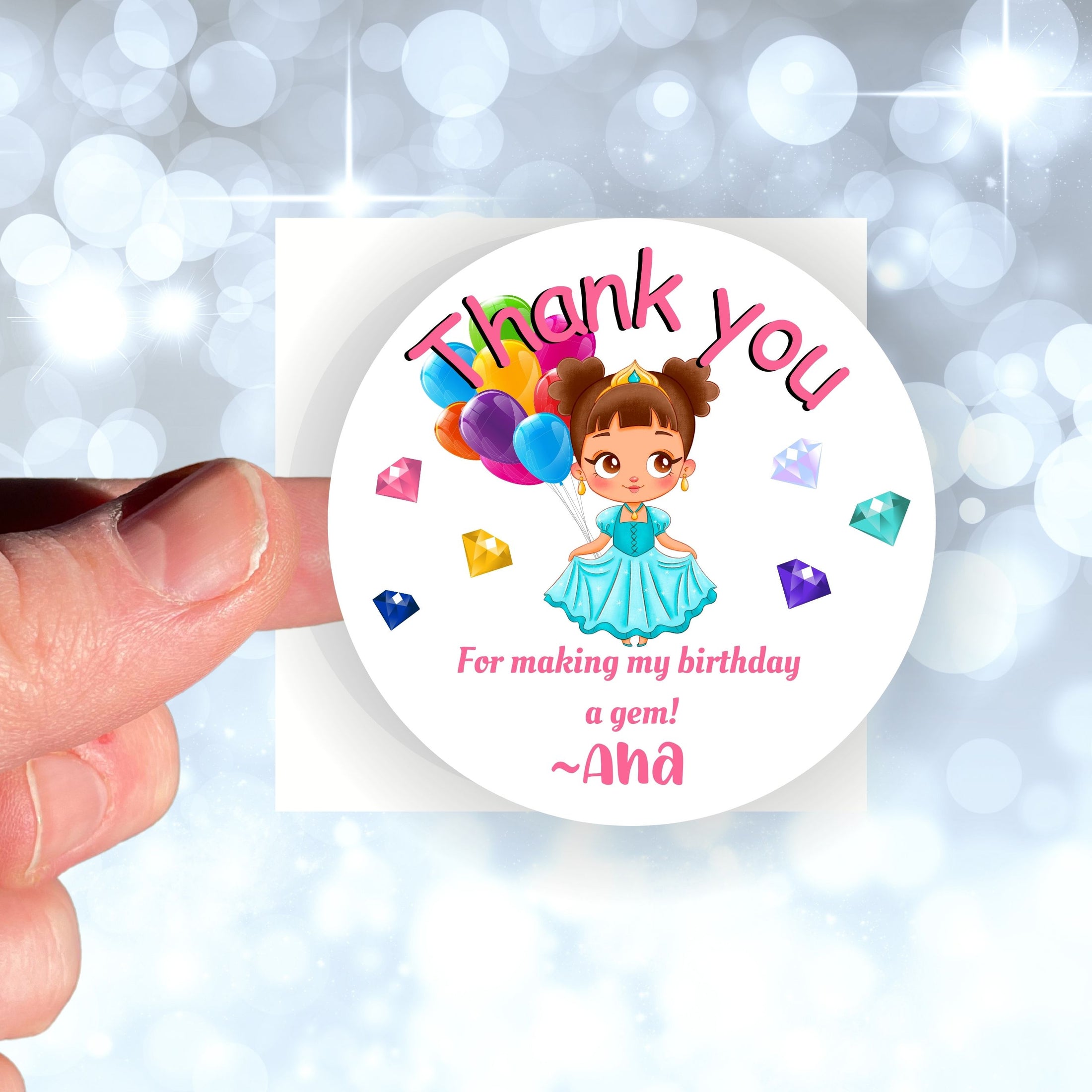 This image shows a hand holding the personalized princess themed thank you sticker.