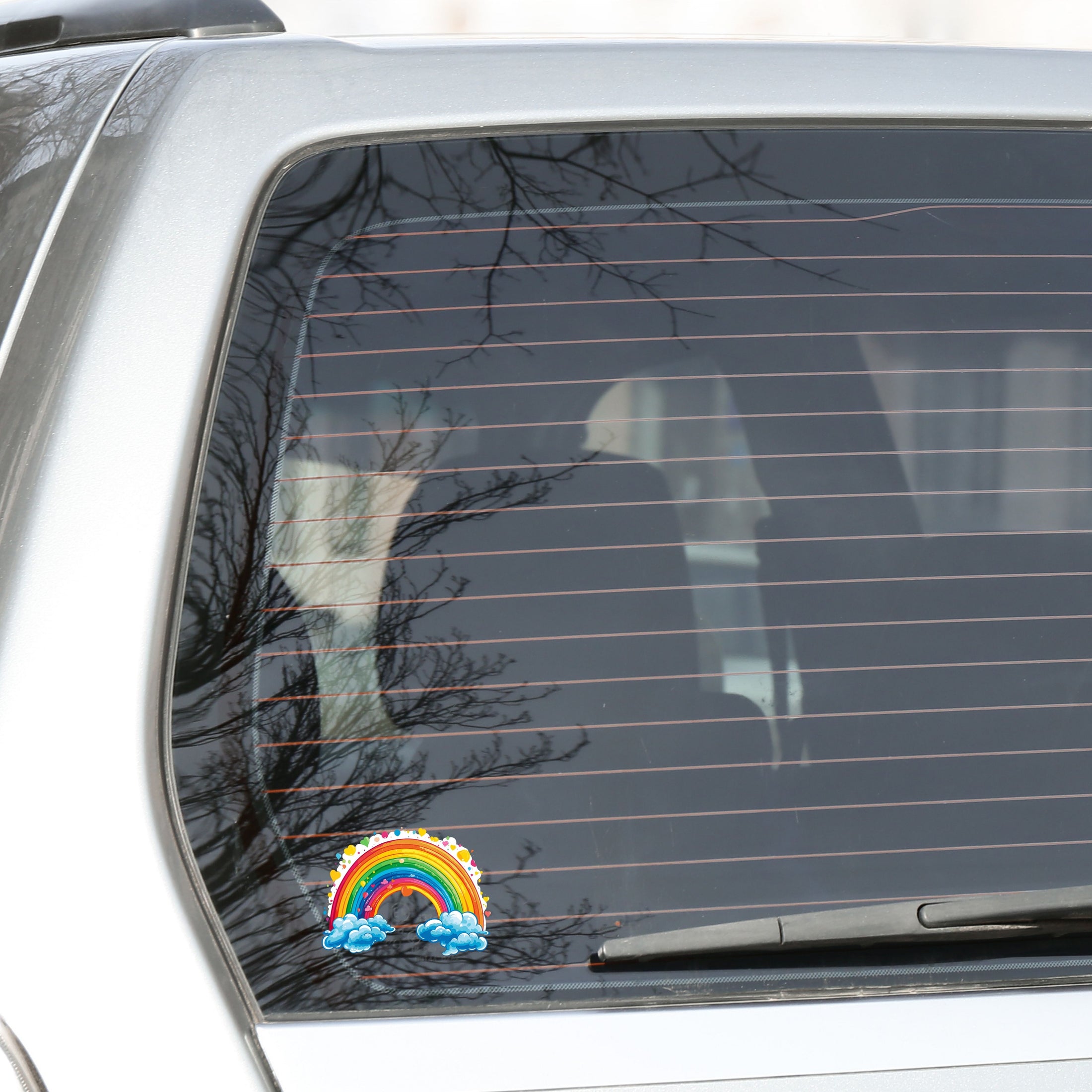 This image shows the rainbow and hearts sticker on the back window of a car.