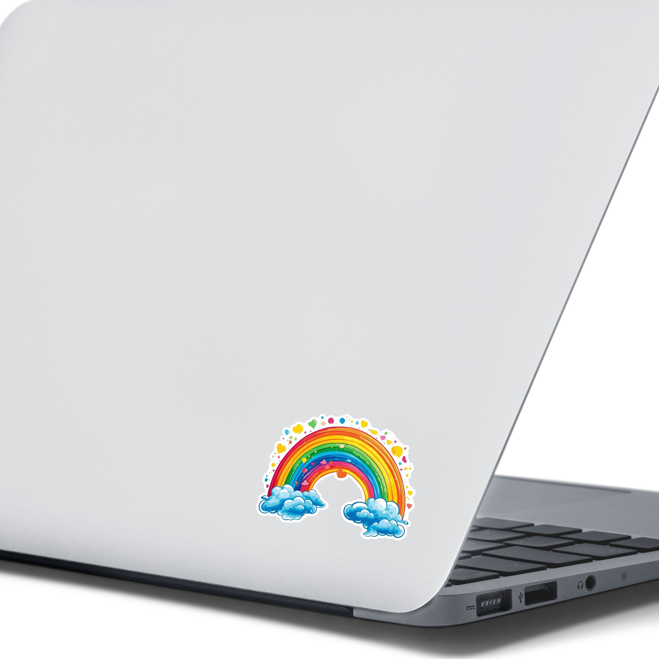 This image shows the rainbow and hearts sticker on the back of and open laptop.