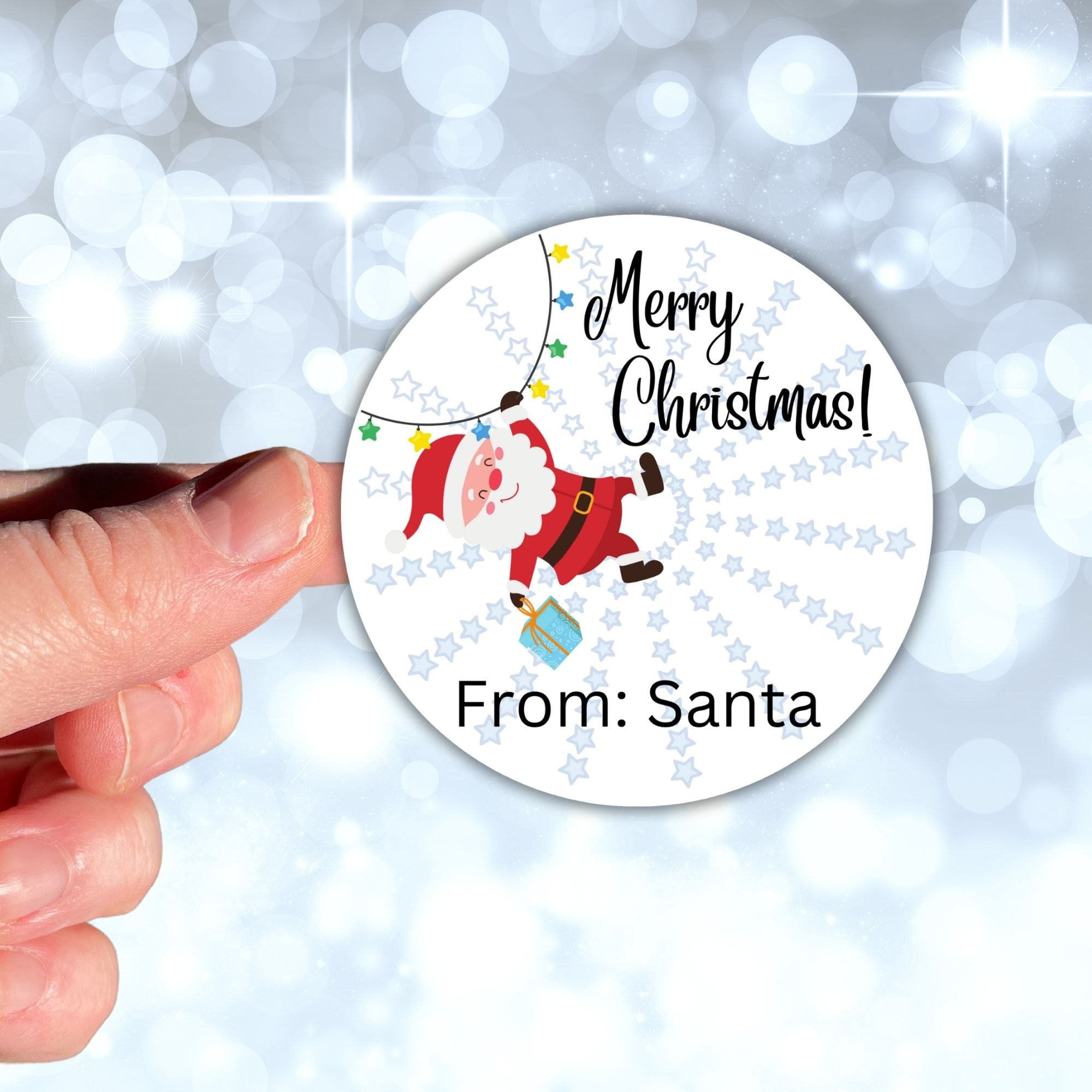 This image shows a hand holding the Personalized Holiday Stickers - Santa Merry Christmas.