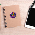 Load image into Gallery viewer, This image shows the personalized school sticker on a notebook next to a smartphone and pen.
