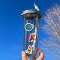 Load image into Gallery viewer, This image shows a water bottle with some of the Sloth Party! stickers applied.

