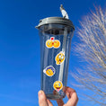Load image into Gallery viewer, This image shows a water bottle with some of the Smiley stickers applied.
