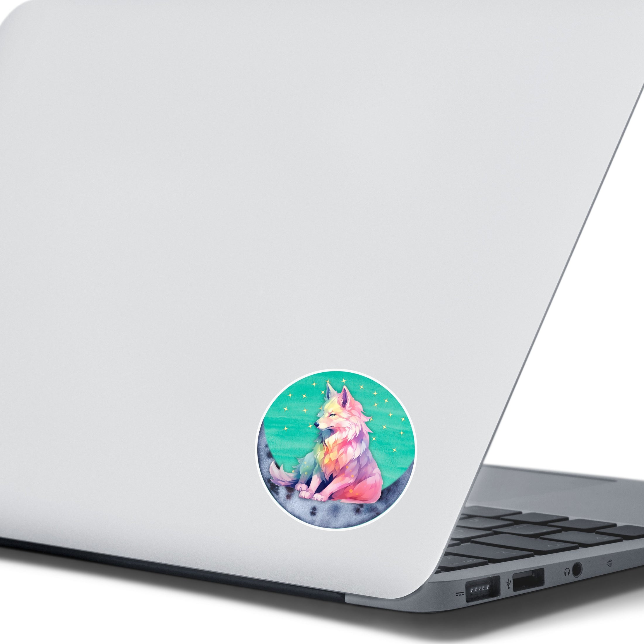 This image shows the starry wolf sticker on the back of an open laptop.