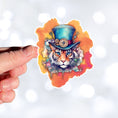 Load image into Gallery viewer, This image shows a hand holding the Steampunk Tiger Die-Cut Sticker.
