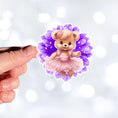 Load image into Gallery viewer, This image shows a hand holding the teddy bear on purple sticker.
