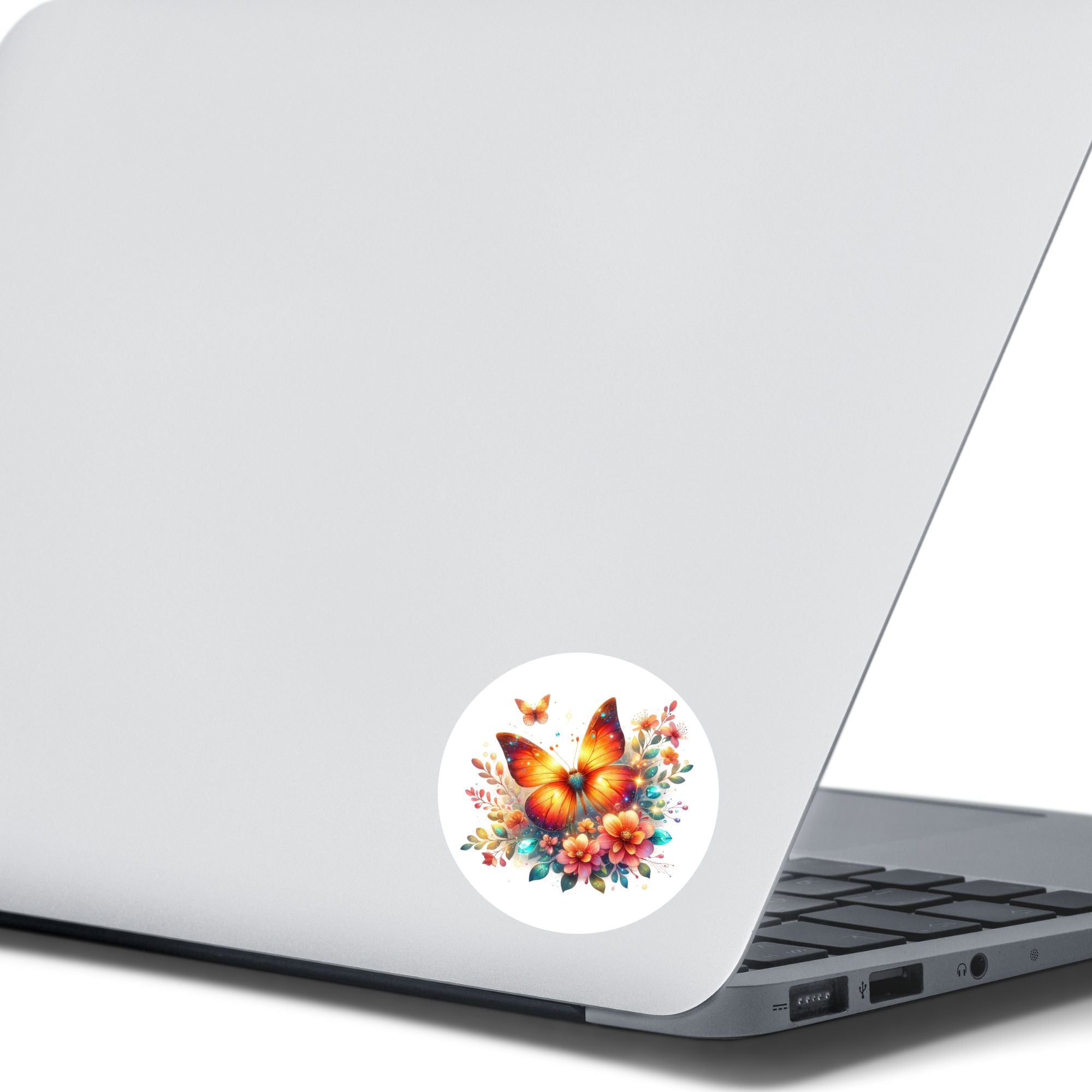 This image shows the Orange Butterfly with Stars Die-Cut Sticker on the back of an open laptop.