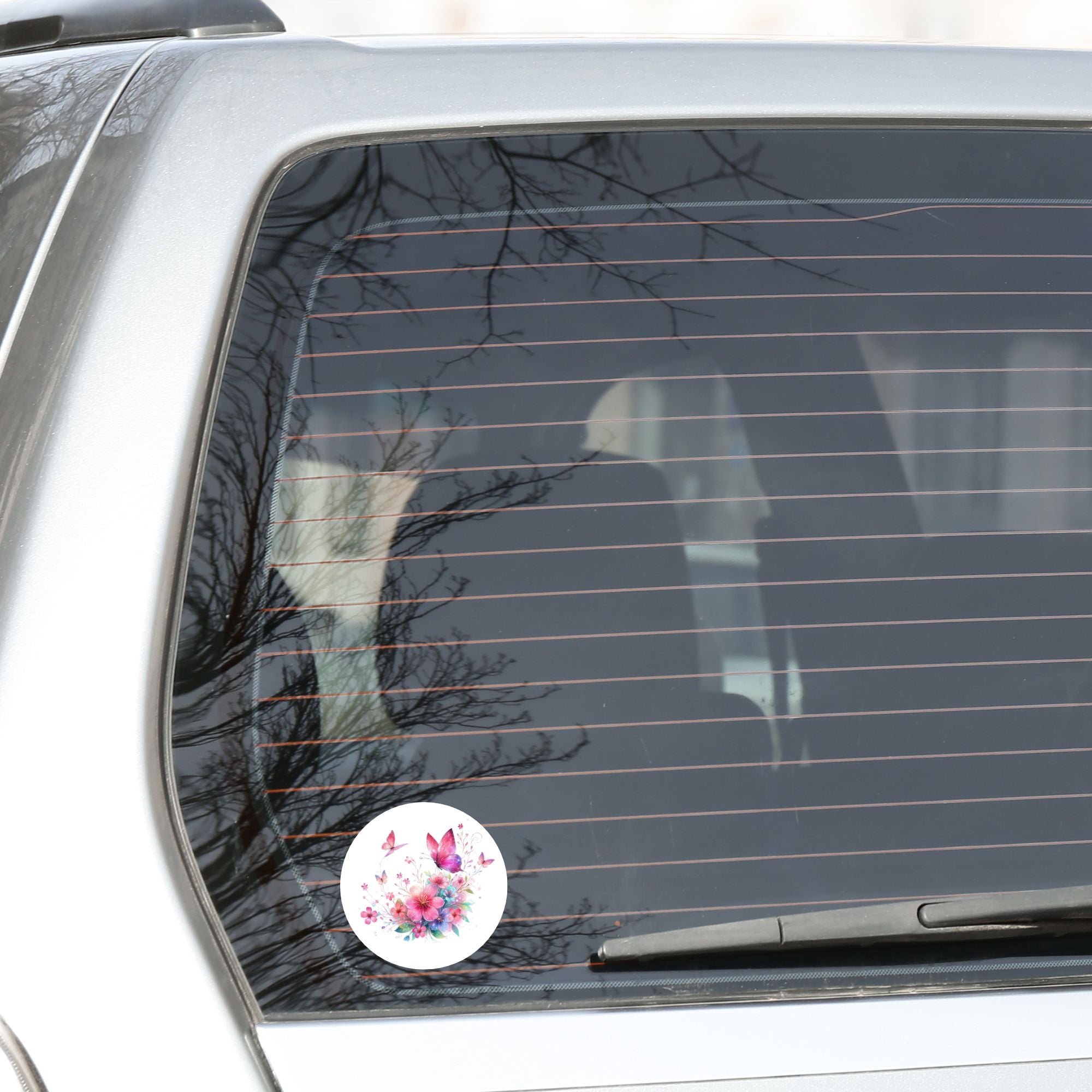 This image shows the Pink Butterfly Die-Cut Sticker on the back window of a car.