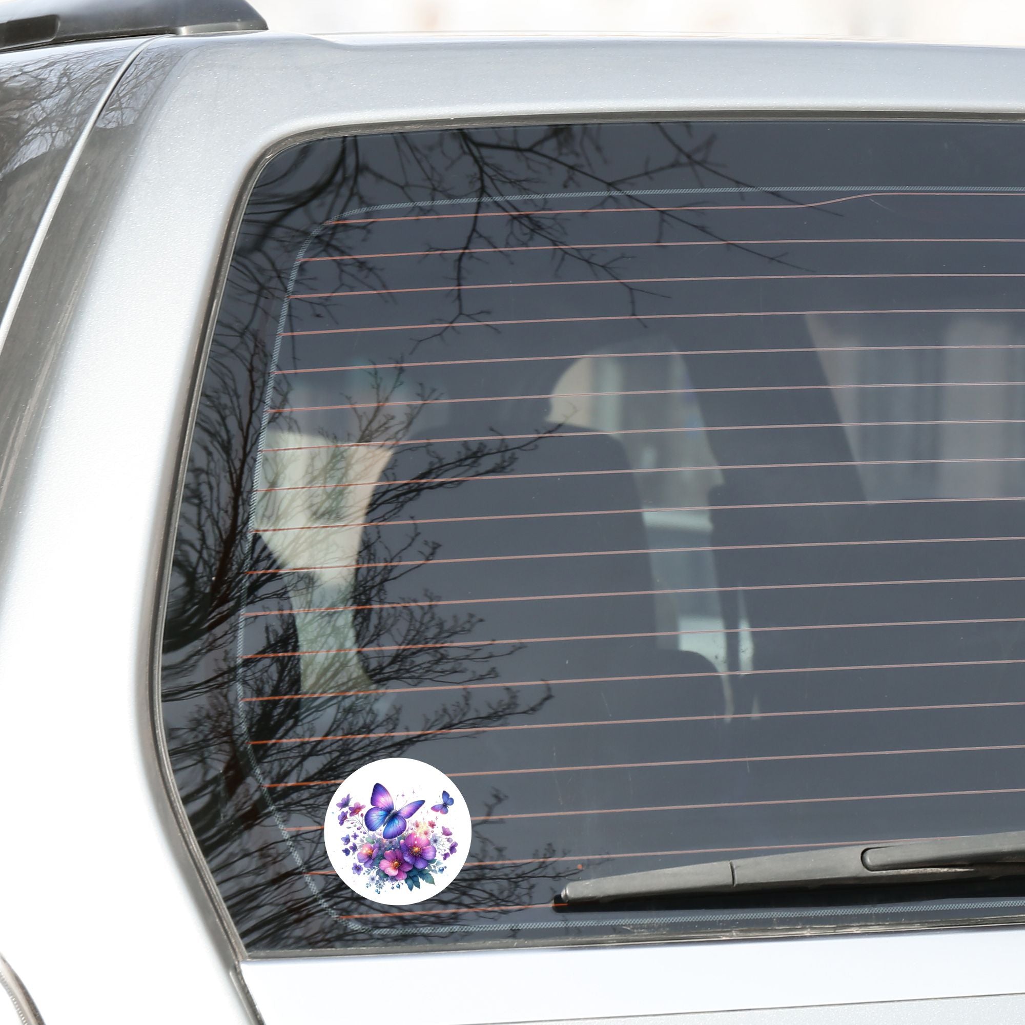 This image shows the Purple Butterfly Die-Cut Sticker on the back window of a car.