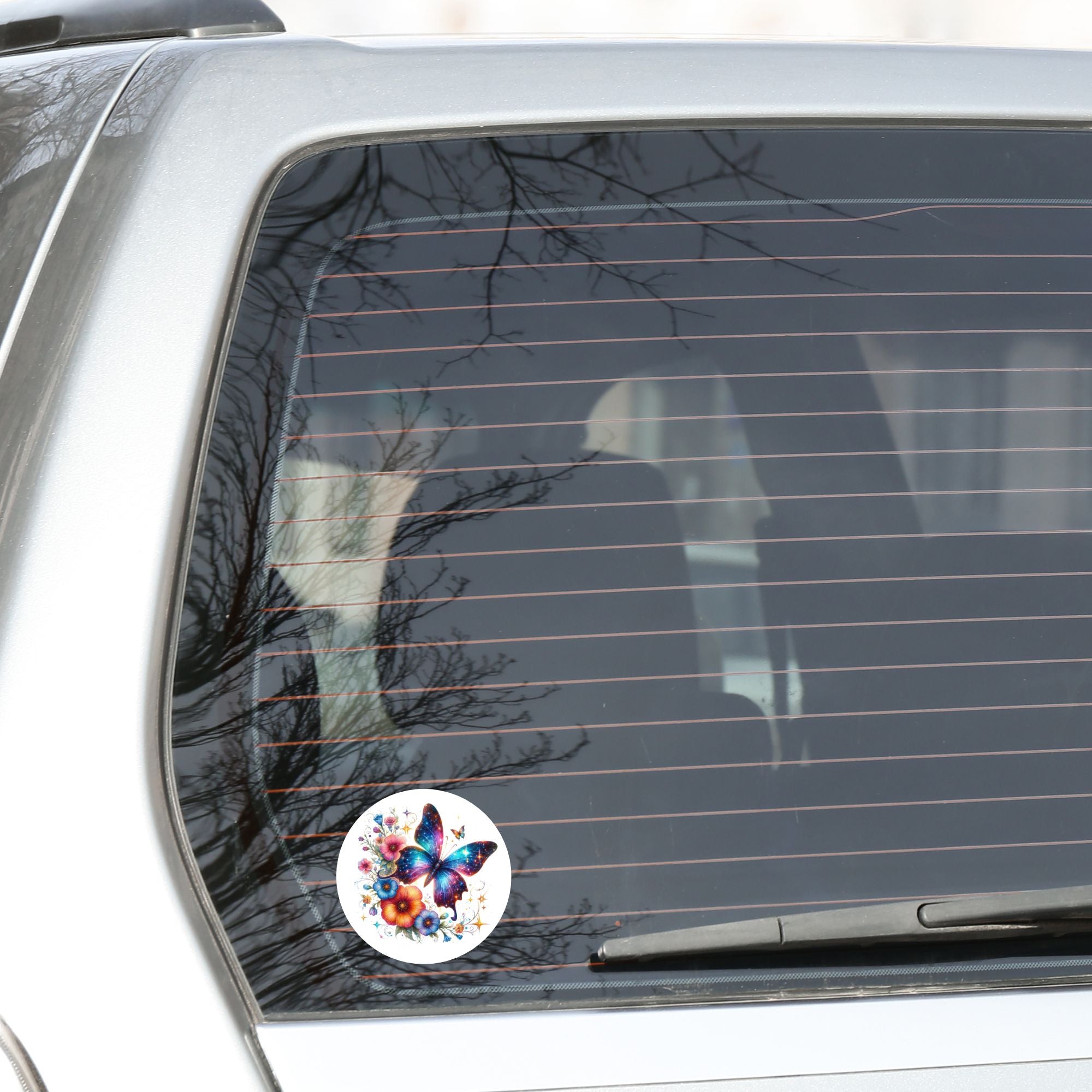 This image shows the Blue Butterfly with Stars die cut sticker on the back window of a car.