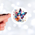 Load image into Gallery viewer, This image shows a hand holding the Blue Butterfly with Stars die cut sticker.
