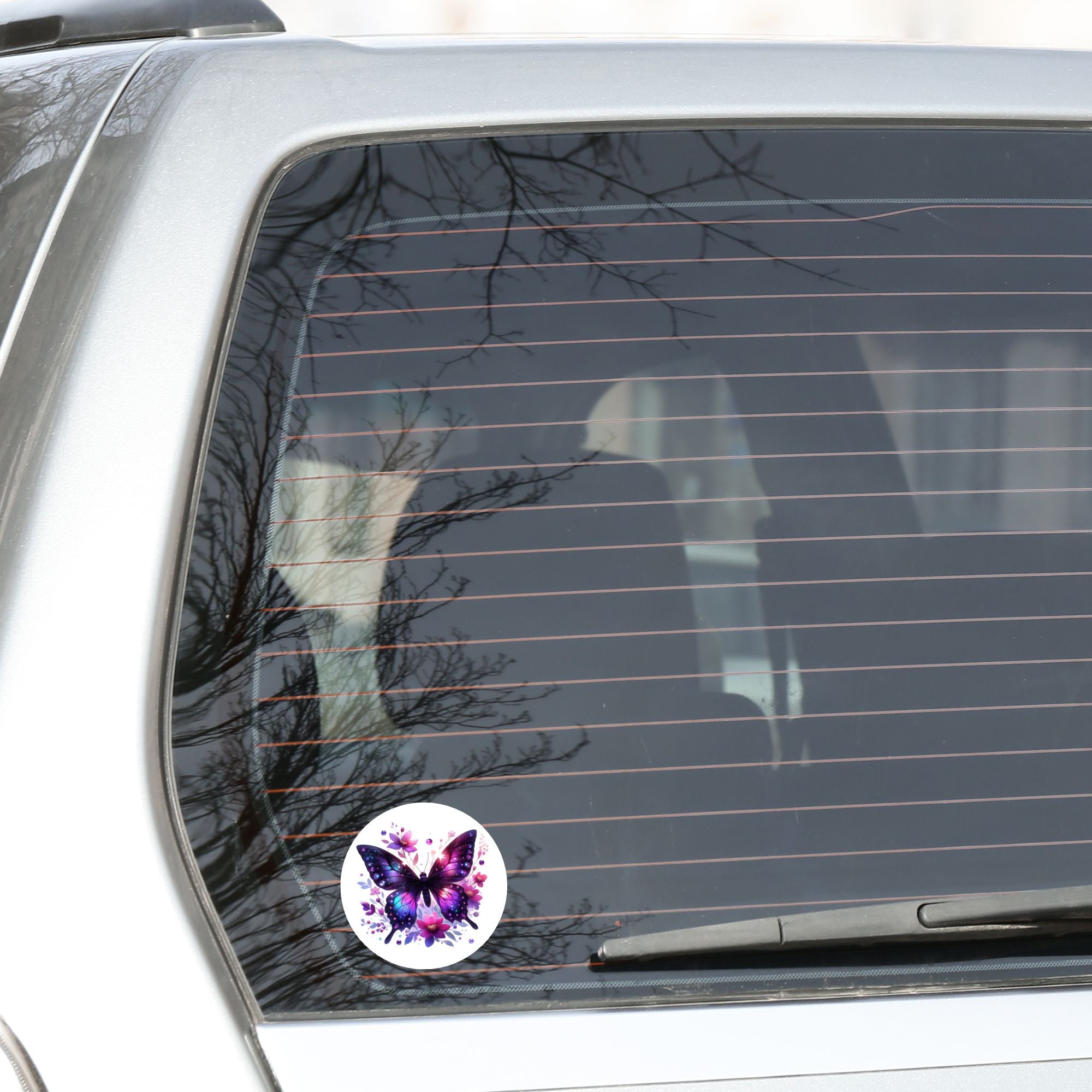 This image shows the Purple Butterfly with Stars die cut sticker on the back window of a car.