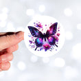 Load image into Gallery viewer, This image shows a hand holding the Purple Butterfly with Stars die cut sticker.
