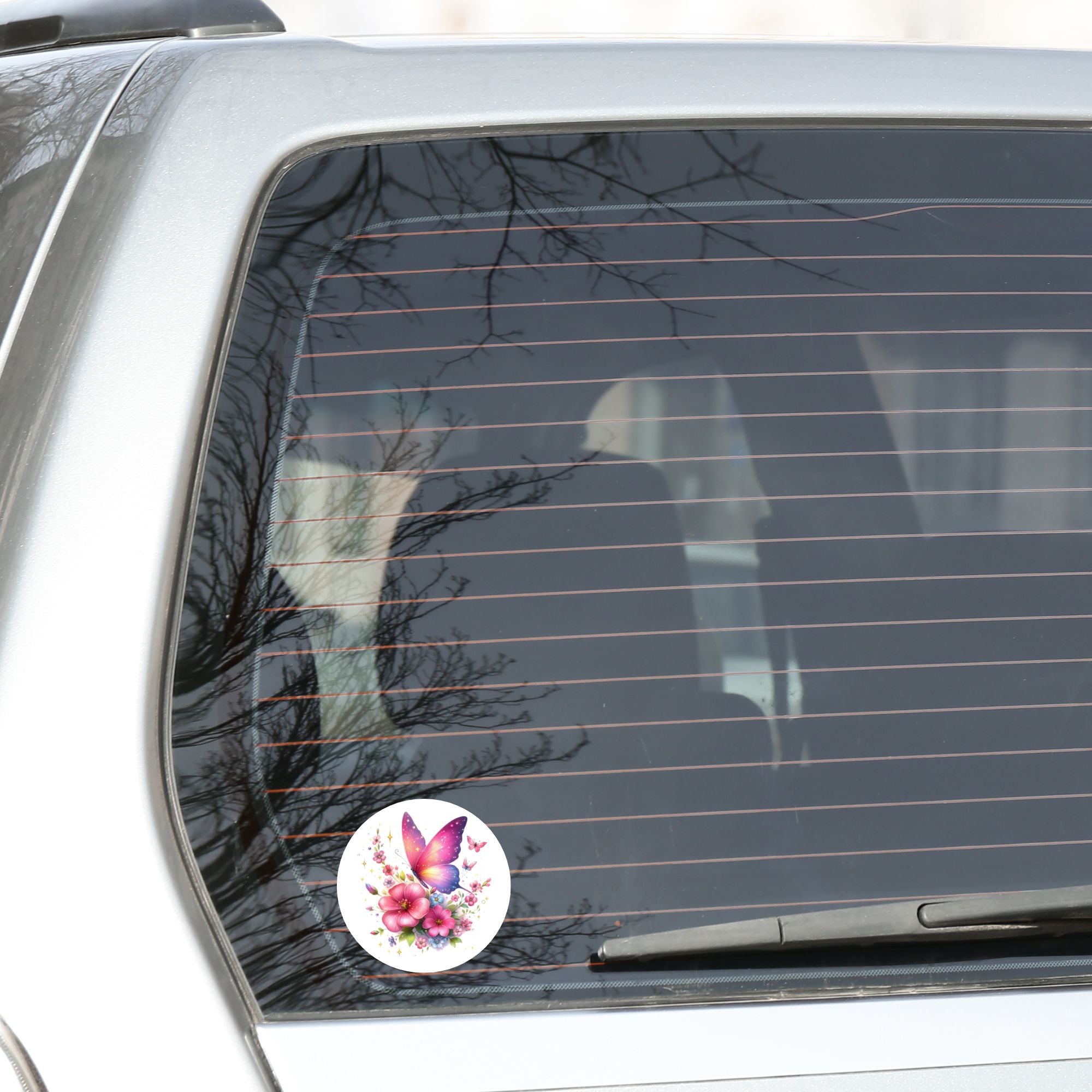 This image shows the Pink Butterfly with Stars Die-Cut Sticker on the back window of a car.