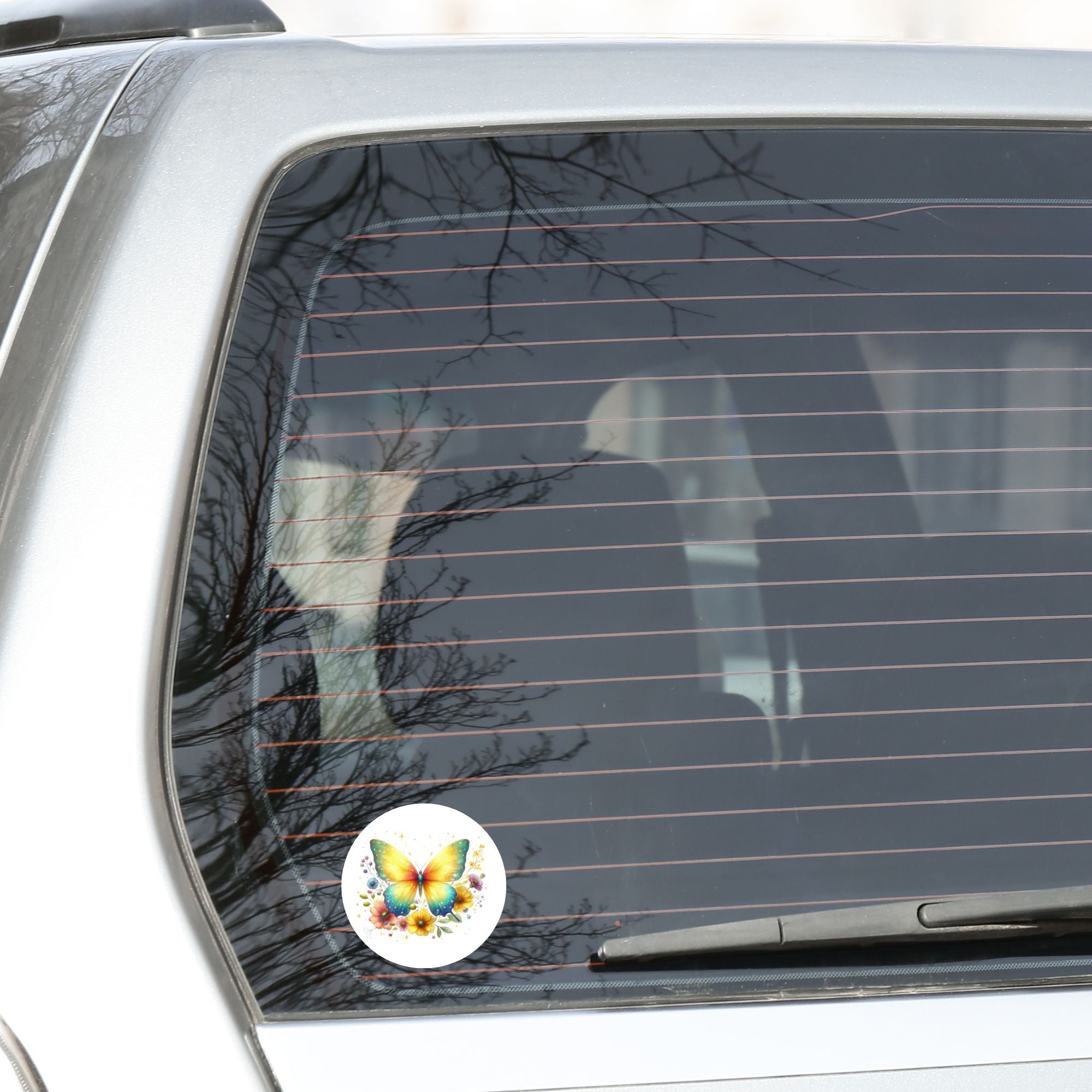 This image shows the Yellow Butterfly Die-Cut Sticker on the back window of a car.