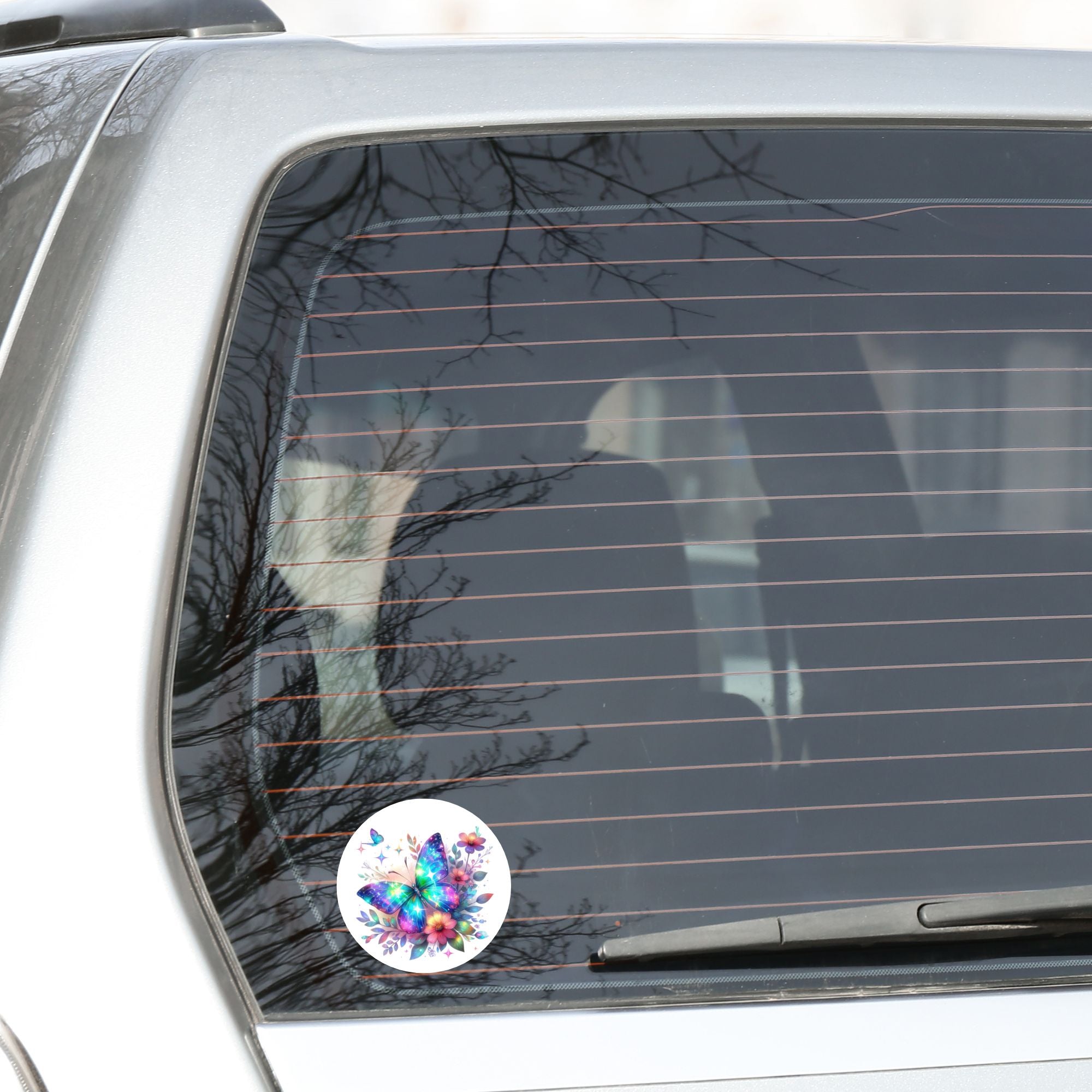 This image shows the Blue and Purple Butterfly with Stars Die-Cut Sticker on the back window of a car.