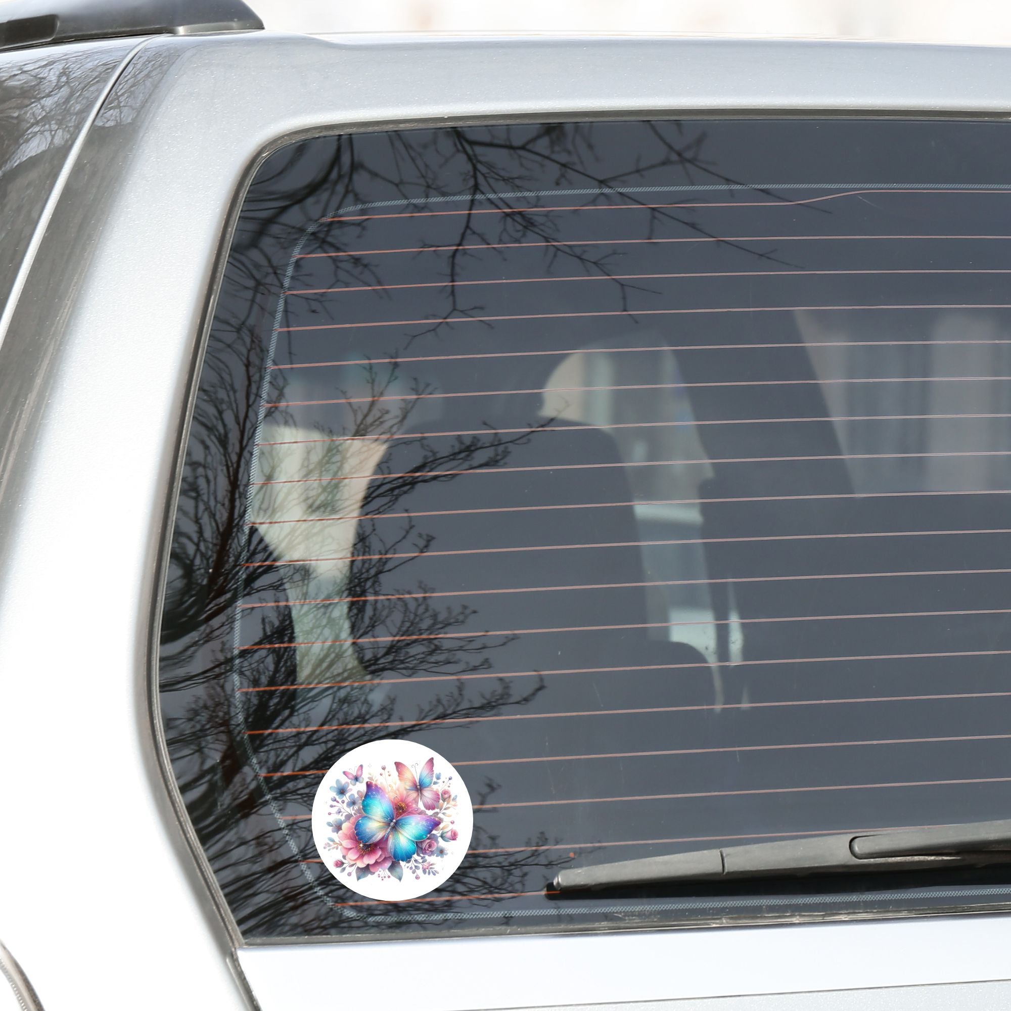 This image shows the Blue and Pink Butterfly with Stars Die-Cut Sticker on the back window of a car.